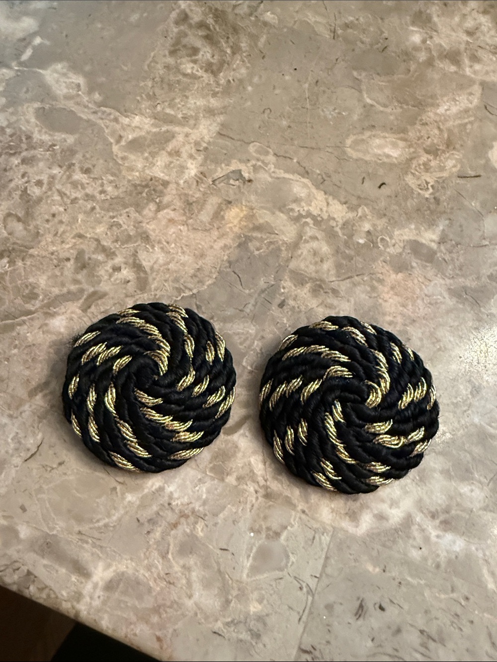 Vintage 1960s black and gold tone large circle fabric twirl clip earrings